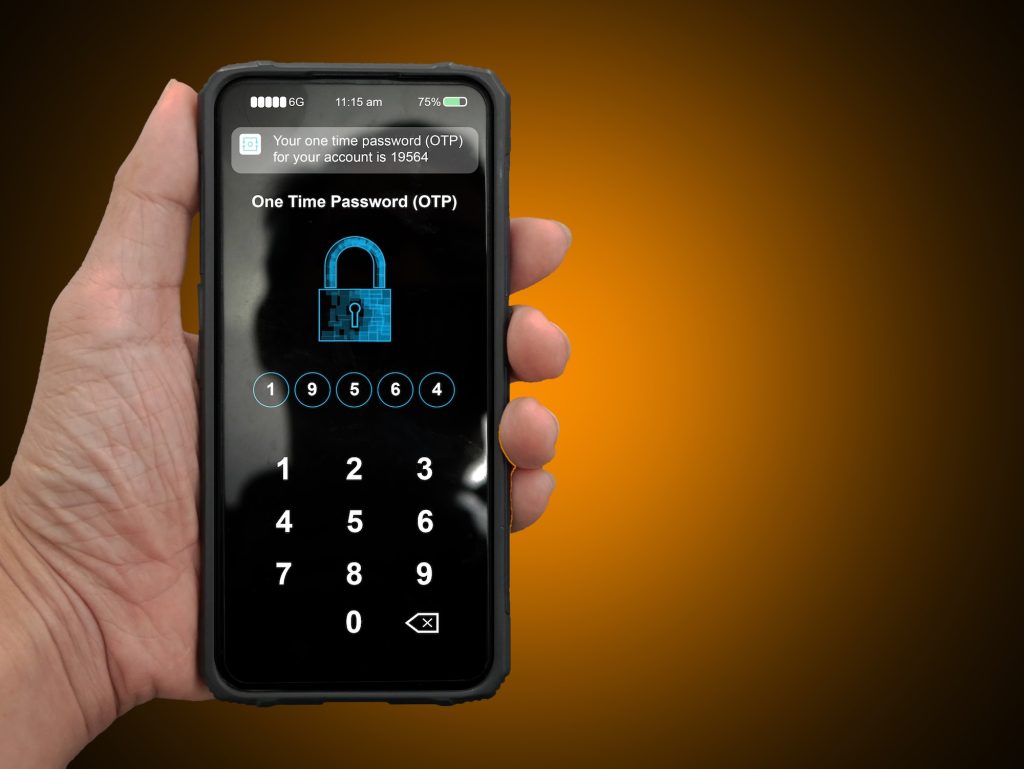 A hand holding a smartphone with filled up one time password for the validation process, Mobile OTP